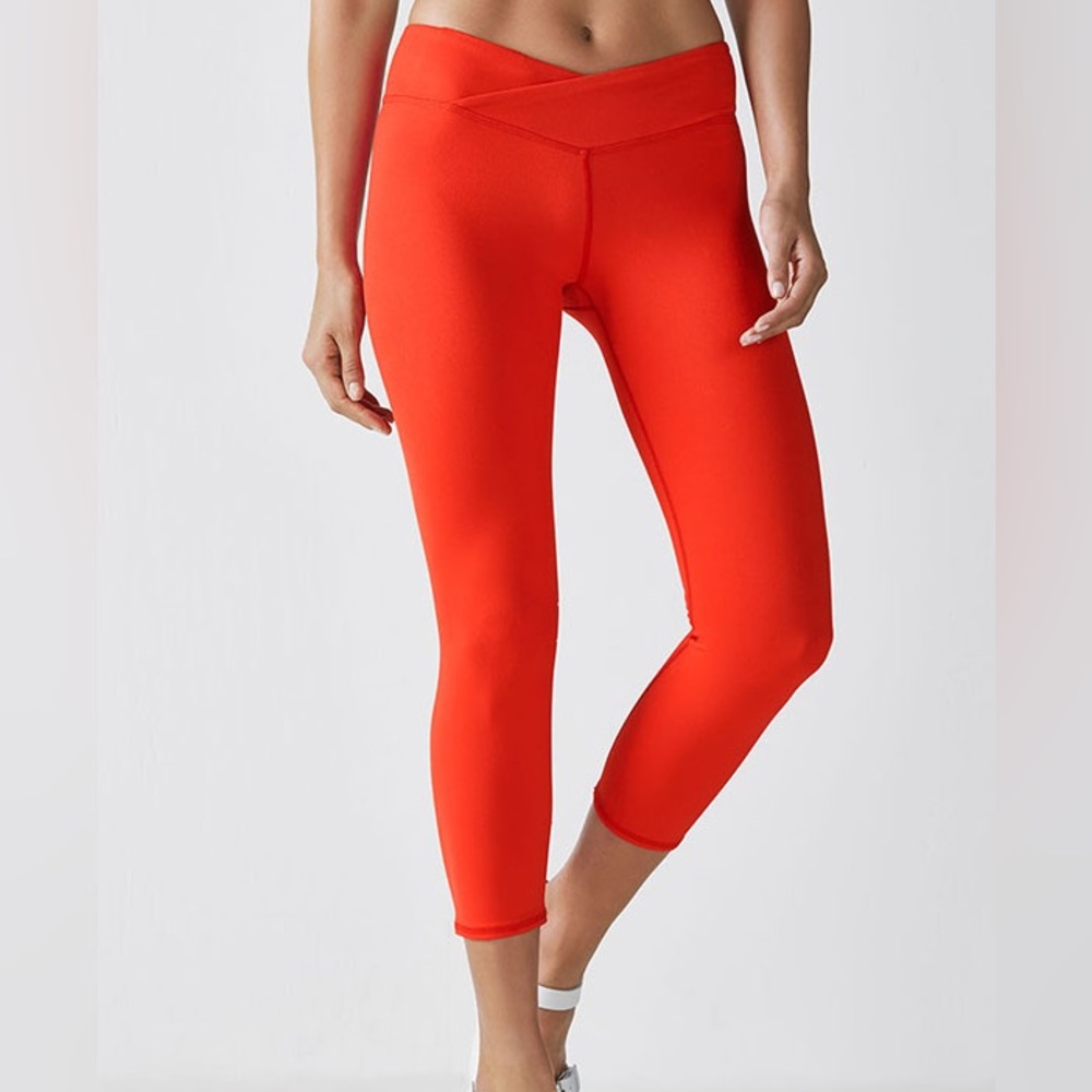 Fabletics Midrise Capris in orange with crossover waistband and hidden pocket
